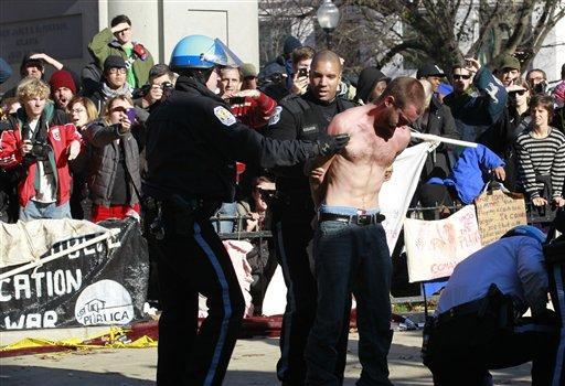 An unidentified protestor is arrested in McPherson Square in downtown Washington Sunday, Dec. 4, 2011. U.S. Park Police are arresting Occupy DC protesters who are refusing to dismantle an unfinished wooden structure erected in the park square overnight. Police Sunday told the protestors they'd need a permit for such a structure and gave them an hour to disassemble it. (AP Photo/Manuel Balce Ceneta)