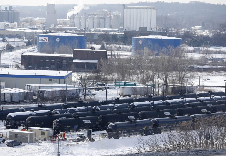 FILE - This Feb. 7, 2014 file photo, shows a view from a nearby apartment building of vehicles driving along Interstate 787 past railroad oil tanker cars that are lined up at Global Partners at the Port of Albany, N.Y. Albany County has issued a moratorium on expansion of crude oil processing at the Port of Albany on the Hudson River, pending a public health investigation. The order issued Wednesday, March 12, 2014 says Global Partners' plan to heat rail tankers of dense crude to liquefy the contents has raised questions about potential public health hazards. (AP Photo/Mike Groll, File)