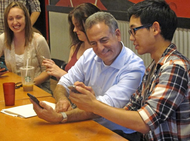 In this Sept. 4, 2015, photo, Democrat Russ Feingold speaks with University of Wisconsin students during a campaign stop in Madison, Wis. (AP Photo/Scott Bauer)