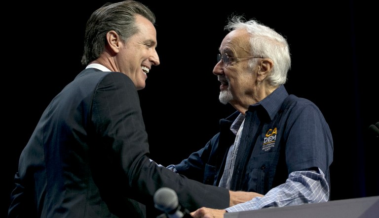 California gubernatorial candidate, Lt. Gov. Gavin Newsom, left, jokes with John Burton, chairman of the California Democratic Party, before addressing the California Democratic Party Convention, Saturday, May 20, 2017, in Sacramento, Calif. (AP Photo/Rich Pedroncelli)