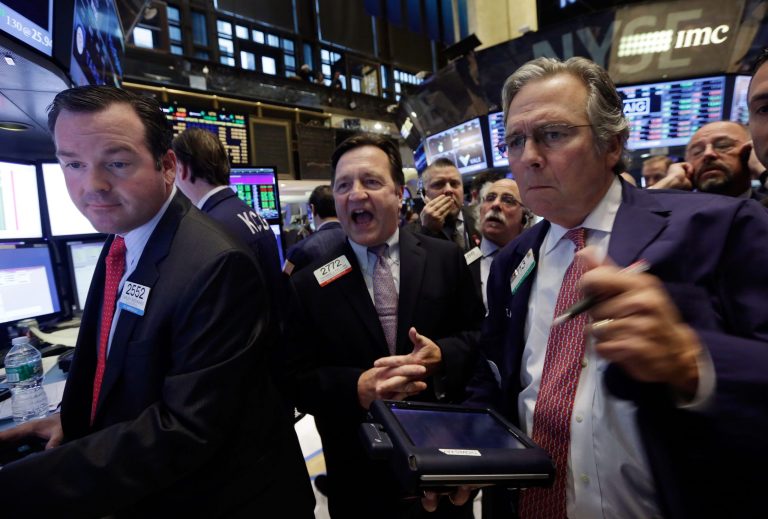 Specialist Thomas Facchine, center, declares shares of Fiat Chrysler Automobiles open as they begin trading, on the floor of the New York Stock Exchange, Monday, Oct. 13, 2014. Fiat Chrysler Automobiles began trading Monday as the newly merged company seeks to raise its profile and give U.S. investors a chance to own a piece of the Chrysler comeback. (AP Photo/Richard Drew)