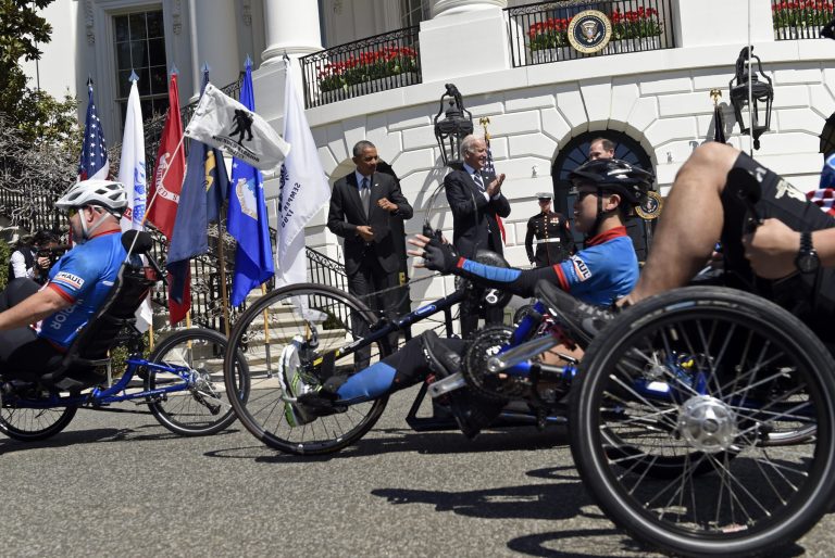 President Barack Obama and Vice President Joe Biden cheer on the Wounded Warrior Project's Soldier Ride as they take a couple laps around the South Lawn of the White House in Washington, Thursday, April 16, 2015, in celebration of the eighth annual Soldier Ride. A cycling event to help Wounded Warriors restore their physical and emotional well-being, the Soldier Ride also raises awareness of our nation's Wounded Warriors who battle the physical and psychological damages of war. (AP Photo/Susan Walsh)