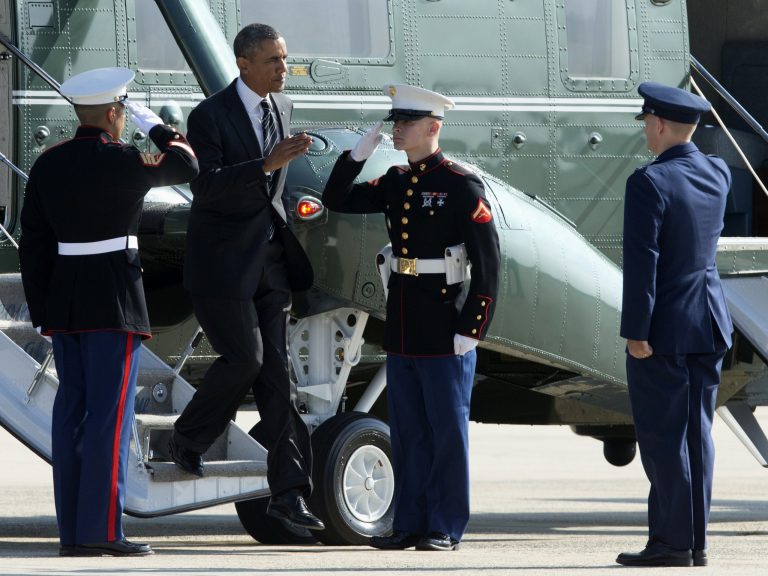   President Barack Obama returns a salute as he is met in the tarmac by the 11th Wing and Joint Base Andrews Commander Col. William Knight, right, as he switched from the Marine One helicopter to Air Force One at Andrews Air Force Base, Md., Thursday, Aug. 22, 2013. President Obama is traveling to New York and Pennsylvania. (AP Photo/Manuel Balce Ceneta)  