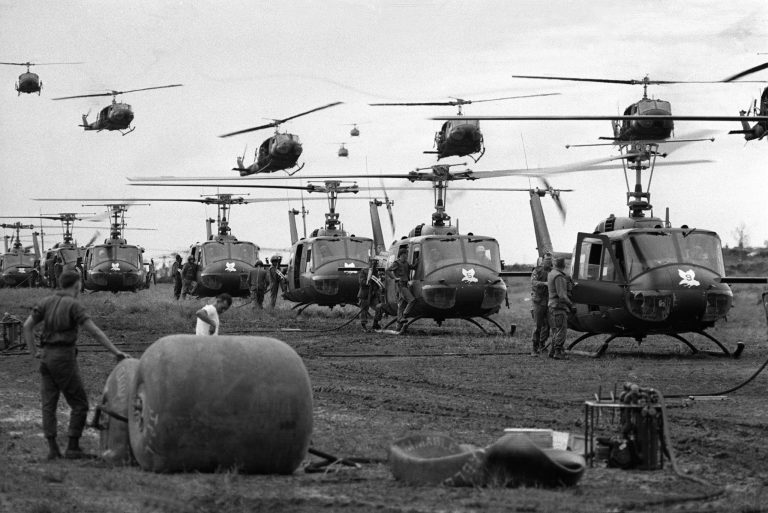 U.S. Huey helicopters fly in formation over a landing zone in South Vietnam during the Vietnam War.  (AP Photo)