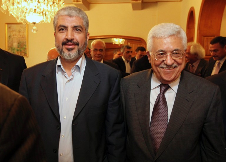 FILE - In this file photo provided on Nov. 24, 2011, by the office of Khaled Mashaal, Palestinian Hamas leader Khaled Mashaal, left, and Palestinian President Mahmoud Abbas are seen together during their meeting in Cairo, Egypt. A spokesman said Monday, May 5, 2014, that Mashaal and Abbas have held a rare meeting in Doha, Qatar, and agreed to move forward with a reconciliation deal between their rival movements. Abbas was in Doha for a grandson's college graduation. (AP Photo/Office of Khaled Meshaal, File)