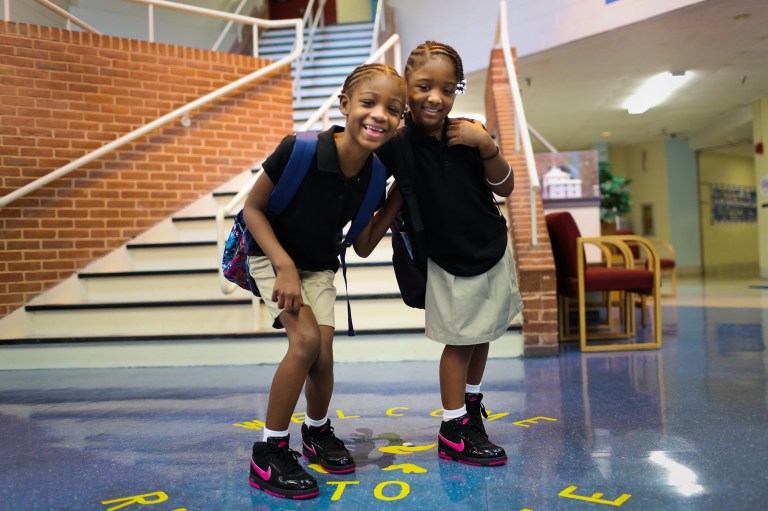 Jayla McFarland (2nd grade) and Keishaunna McFarland (1st grade) begin their first day back at Riverdale Elementary School, Monday, August 20, 2012