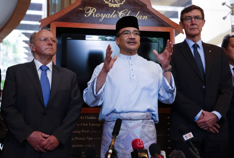 Malaysian Defense Minister and acting Transport Minister Hishammuddin Hussein, center, speaks to reporters as the chief coordinator of the Joint Agency Coordination Center (JACC) Angus Houston, right, and President of French Aviation Accident Investigation Bureau Jean-Paul Troadec listen in Kuala Lumpur, Malaysia, Friday, May 2, 2014. Air traffic controllers did not realize that Malaysia Airlines Flight 370 was missing until 17 minutes after it disappeared from civilian radar, according to a preliminary report on the plane's disappearance released Thursday by Malaysia's government. The government also released other information from the investigation into the flight, including audio recordings of conversations between the cockpit and air traffic control, the plane's cargo manifest and its seating plan. (AP Photo/Vincent Thian)