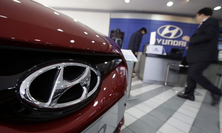 The logo of Hyundai Motor Co. is seen on a car at the automaker's showroom in Seoul, South Korea, Thursday, Jan. 23, 2014. Hyundai Motor Co. said its fourth-quarter profit increased 13 percent over a year earlier thanks to higher overseas sales. (AP Photo/Lee Jin-man)