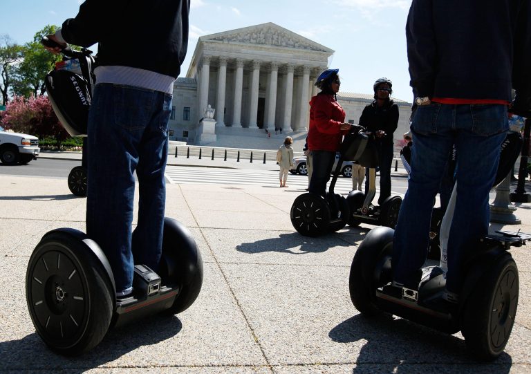 Tourists ride on Segway scooters as they pass in front of the U.S. Supreme Court in Washington, DC. (Alex Wong/Getty Images)