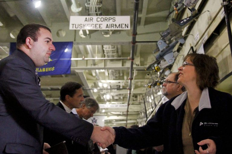 In this May 16, 2014 photo, Mike Zulauf, 2008 graduate of the Air Force Academy, shakes hands with Sandra Modena, Sales Manager at Trillium Staffing, at the annual veterans job fair aboard the LST in downtown Muskegon Mich. The Labor Department reports the number of people who applied for unemployment benefits last week on Thursday, May 22, 2014. (AP Photo/The Muskegon Chronicle, Madelyn Hastings)