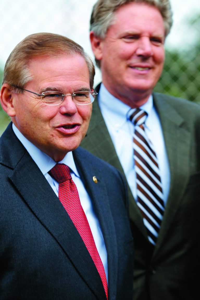 In this Thursday, Sept. 27, 2012 photo, as Congressman Frank Pallone, right, looks on, U.S. Sen. Robert Menendez, D-N.J., speaks to a gathering about the progress made in restoring the contaminated watershed at the Atlantic Resources Corporation Superfund in Sayreville, N.J. New Jersey's U.S. Senate race will probably turn out the same as the presidential election. If President Barack Obama wins re-election, Menendez is almost assured of also being returned to office. But if Republican challenger Mitt Romney can keep it close in New Jersey, Senate challenger Joe Kyrillos has a shot at unseating the incumbent. (AP Photo/Mel Evans)