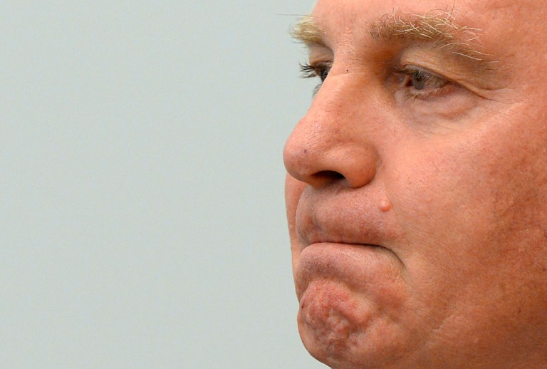Uli Hoeness,  president of German soccer club Bayern Munich,  waits at the regional court in Munich, southern Germany Thursday March 13, 2014. Hoeness has been  sentenced to 3 years and 6 months in prison on Thursday  in a tax evasion case.  The 62-year-old Hoeness was charged with dodging 3.5 million euros (US $4.85 million) in taxes, but when his trial opened Monday he admitted avoiding 15 million euros more. Then it came out through an examination of documents he provided to investigators shortly before the trial that he owed 27.2 million euros in total - a number Hoeness did not dispute.  (AP Photo/Christof Stache,Pool)
