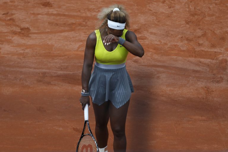 Serena Williams of the U.S. covers her face after missing a return during the second round match of the French Open tennis tournament against Spain's Garbine Muguruza at the Roland Garros stadium, in Paris, France, Wednesday, May 28, 2014. Williams lost in two sets 2-6, 2-6. (AP Photo/Darko Vojinovic)