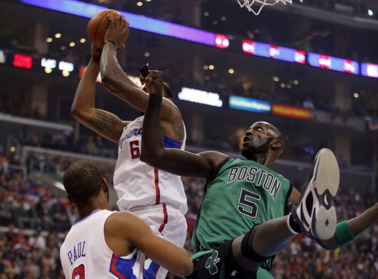   Los Angeles Clippers' DeAndre Jordan, top left, grabs a rebound against Boston Celtics' Kevin Garnett in the first half of an NBA basketball game in Los Angeles, Thursday, Dec. 27, 2012. (AP Photo/Jae C. Hong)  