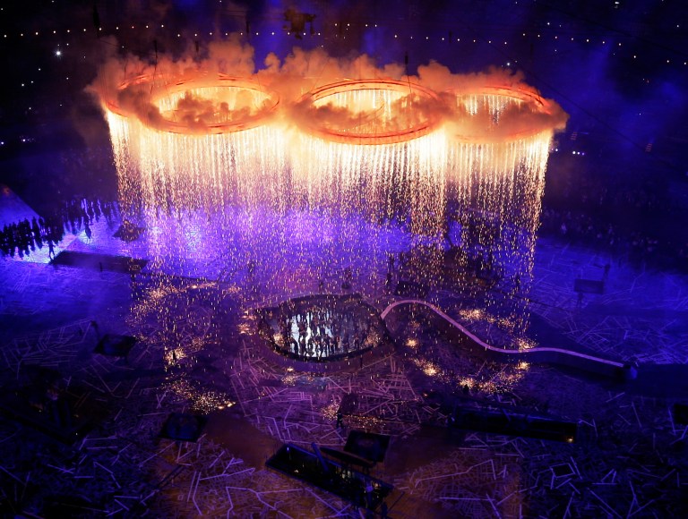   FOR USE AS DESIRED, YEAR END PHOTOS - FILE - In this July 27, 2012 file photo, the Olympic rings light up the stadium during the Opening Ceremony at the 2012 Summer Olympics in London. (AP Photo/Morry Gash, Pool, File)  