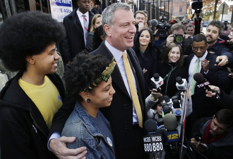 Democratic mayoral candidate Bill de Blasio embraces his daughter Chiara as he talks to the media after voting Tuesday in the Park Slope neighborhood of the Brooklyn borough of New York. (AP/Mark Lennihan)