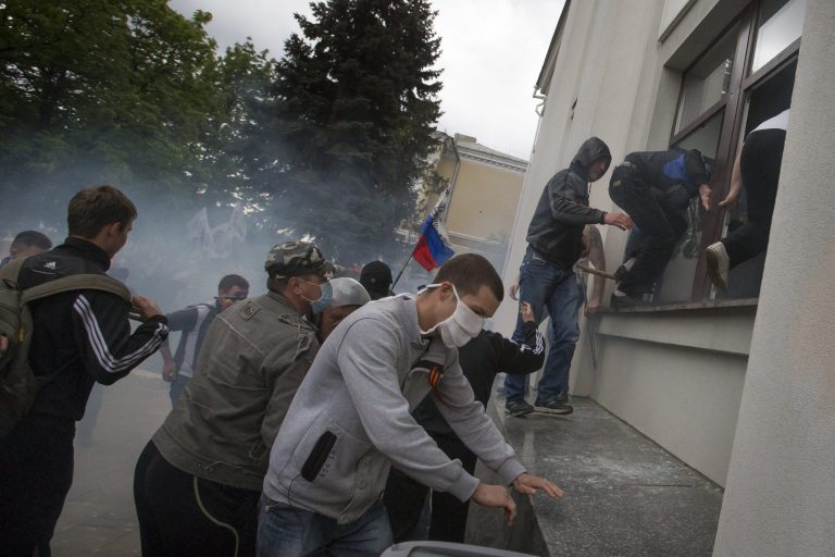 Pro-Russian activists storm an administration building in the center of Luhansk, Ukraine, one of the largest cities in Ukraine's troubled east, Tuesday, April 29, 2014, as demonstrators demand greater autonomy for Ukraine's regions.  The action on Tuesday further raises tensions in the east, where insurgents have seized control of police stations and other government buildings in at least 10 cities and towns.(AP Photo/Alexander Zemlianichenko)