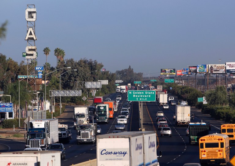 File - This Oct. 5, 2012 file photo shows truckers and cars shown driving along California State Route 99 in Fresno, Calif. A new state of California survey ranks Fresno and other communities in the Central Valley as the hardest-hit by pollution, joblessness and other problems. (AP Photo/Gary Kazanjian, file)