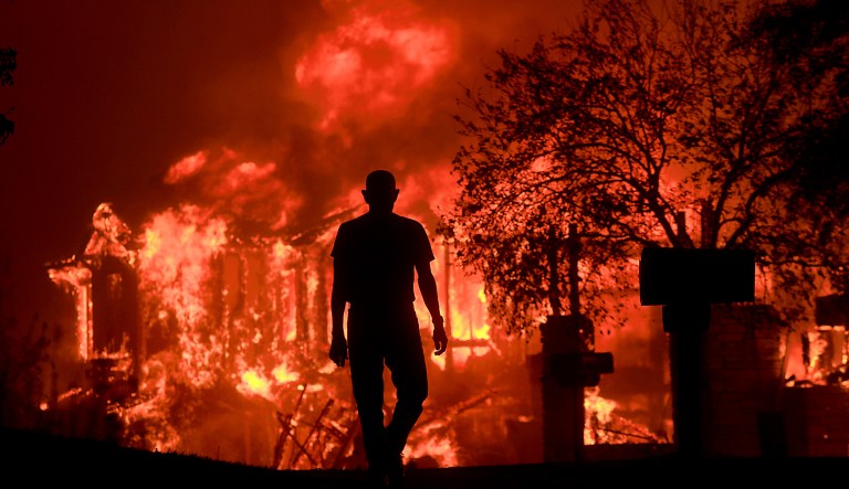 Jim Stites watches part of his neighborhood burn in Fountaingrove, California, Monday Oct. 9, 2017. 