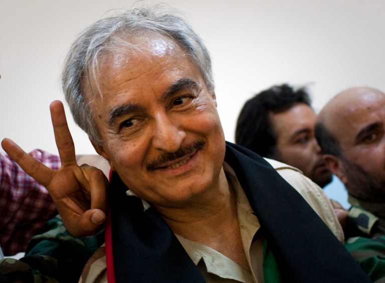 FILE - In this Friday, March 18, 2011 file photo, then Libyan senior Rebel commander Khalifa Hifter leaves a press conference in the court house in the center of Benghazi, eastern Libya. Libya's army chief ordered the deployment of Islamist-led militias to the capital Tripoli on Monday, May 19, 2014 in response to the storming of parliament by forces loyal to a renegade general, paving the way for a possible showdown between rival militia fighters. The revolt by Gen. Khalifa Hifter threatens to detonate the long volatile divisions among the multiple militias that dominate Libya amid the weakness of the central government and military. (AP Photo/Anja Niedringhaus, File)