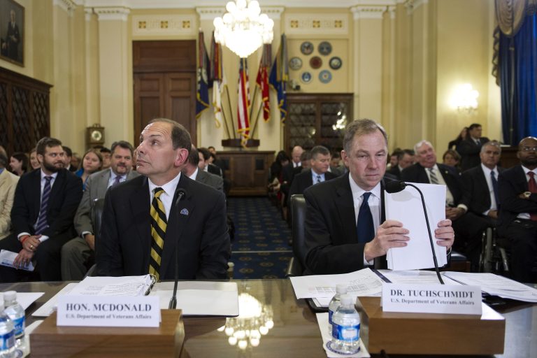 Veterans Affairs Secretary Robert McDonald, left, and Jame Tuchschmidt, M.D., acting principal deputy under secretary for health, Veteran Affairs Administration, wait to testify about pending Veteran Affairs healthcare budget shortfall and system shutdown at a House Veterans Affairs Committee hearing on Capitol Hill in Washington, Wednesday, July 22, 2015. (AP Photo/Cliff Owen)