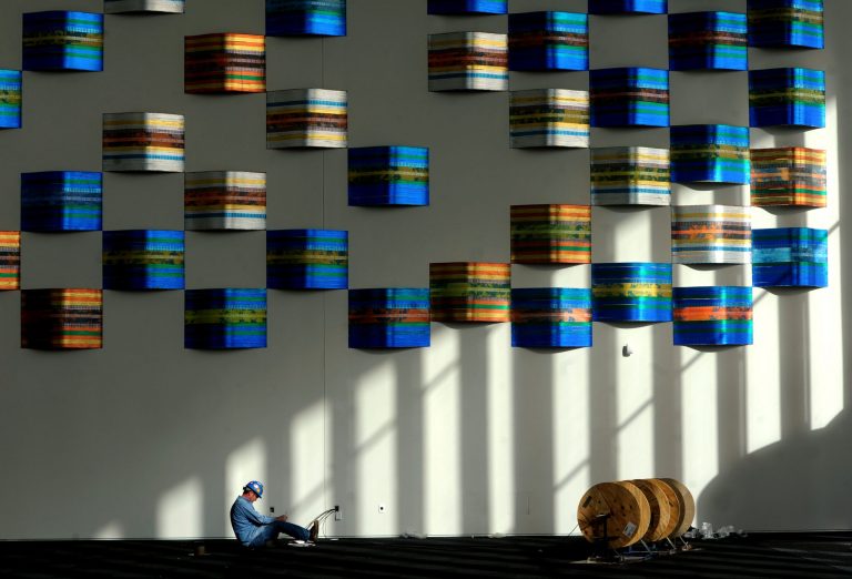 FILE - In this Jan. 27, 2014 file photo, Shelby Whitledge, an electrician with Beltline Electric company, works on electrical data in the lobby of the downtown Owensboro Convention Center in Owensboro, Ky. The Commerce Department reports on U.S. construction spending in January on Monday, March 3, 2014. (AP Photo/ Messenger-Inquirer, Jenny Sevcik)