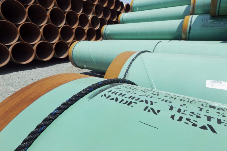 In this May 24, 2012 photo, some of about 500 miles worth of coated steel pipe manufactured by Welspun Pipes, Inc., originally for the Keystone oil pipeline, is stored in Little Rock, Arkansas.
