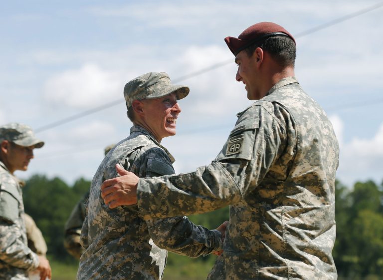 U.S. Army First Lt. Shaye Haver, left, is congratulated by an unidentified soldier before an Army Ranger school graduation ceremony Friday, Aug. 21, 2015, at Fort Benning, Ga. Haver and Capt. Kristen Griest became the first female graduates of the Army's rigorous Ranger School, putting a spotlight on the debate over women in combat. (AP Photo/John Bazemore)