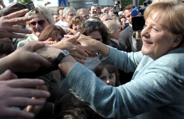 FILE - In this May 15, 2009 file photo, German chancellor Angela Merkel greets well-wishers, in Detmold, Germany. Ordinary Germans are spooked about the future. Businesses see black clouds on the horizon. And an economy that has been the envy of Europe is already showing cracks, shrinking last quarter under the strain of conflicts in Ukraine and elsewhere. It might seem like enough to put any leader into trouble. But Chancellor Angela Merkel's popularity remains sky-high _ with nobody in sight to touch her. (AP Photo/dpa, Franz-Peter Tschauner, File)