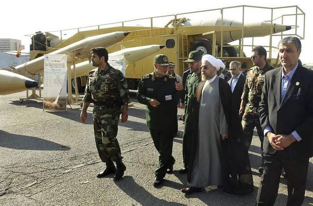 Iran's President Hassan Rouhani, second right in first row, visits a defense industry display. AP Photo