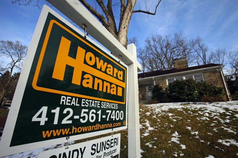 In this Thursday, Jan. 9, 2014, photo, a  for sale sign hangs in front of a house in Mount Lebanon, Pa. The National Association of Realtors reports on existing-home sales in January on Friday, Feb. 21, 2014. (AP Photo/Gene J. Puskar)