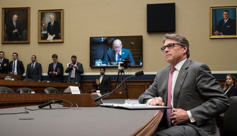 Energy Secretary Rick Perry listens to a statement by House Energy and Commerce Committee Chairman Greg Walden, R-Ore., on video monitor, during a hearing about the electrical grid, on Capitol Hill in Washington, Thursday, Oct. 12, 2017. (AP Photo/J. Scott Applewhite)