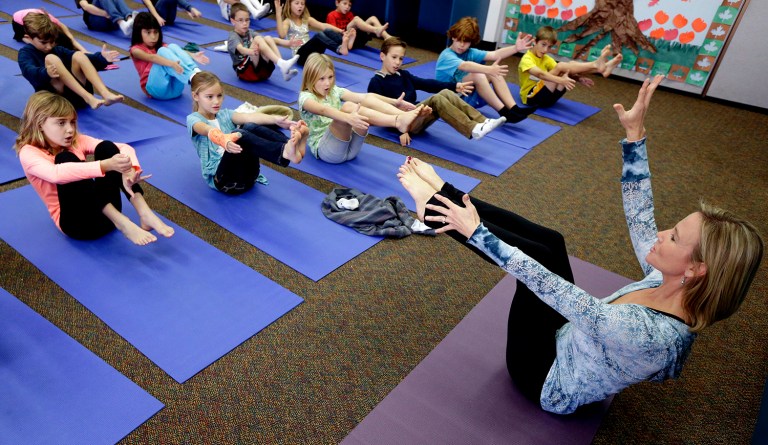 The Encinitas Union School District in California will begin requiring one day of yoga instruction per week for its students. The program will cost $416,000 next school year. (AP Photo/Gregory Bull,File)