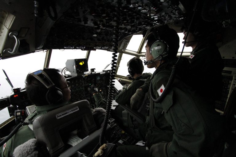 Japanese Air Self-Defense Force's Capt. Junichi Tanoue, left, co-pilot Ryutaro Hamahira, second from left, and engineer Noriyuki Yamanouchi, second from right, scan the ocean aboard a C130 aircraft while it flies over the southern search area in the southeastern Indian Ocean, 200 to 300 kilometers (124 to 186 miles) south of Sumatra, Indonesia, Friday, March 21, 2014. Search planes scoured a remote patch of the Indian Ocean but came back empty-handed Friday after looking for any sign of the missing Malaysia Airlines jet, another disappointing day in one of the world's biggest aviation mysteries. (AP Photo/Koji Ueda)