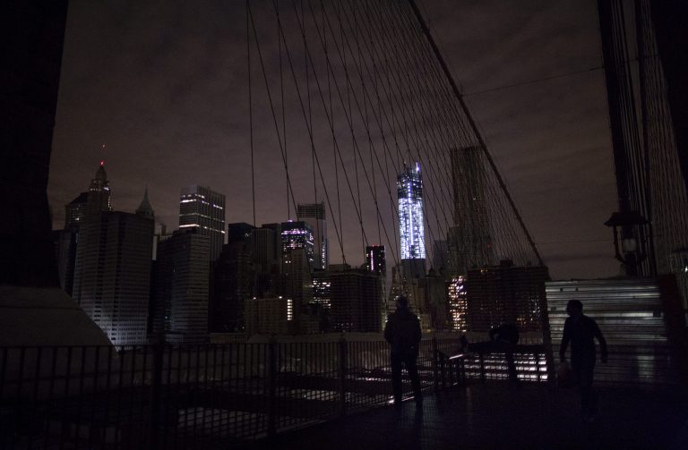   FILE - In this Nov. 1, 2012 file photo, much of lower Manhattan remains dark in the wake of Superstorm Sandy, as viewed from the darkened Manhattan side of the Brooklyn Bridge in New York. 2012 was a year of storms, of raging winds and rising waters, but also broader turbulence that strained our moorings. (AP Photo/Craig Ruttle, File)  