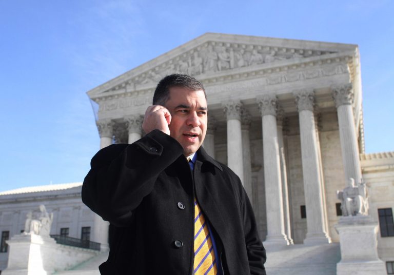 In this Jan. 21, 2010, photo Citizens United President David Bossie talks on his cell phone outside the Supreme Court in Washington after the court's controversial, 5-4 decision in the Citizens United case, which allowed corporations and labor unions to spend unlimited sums in support of or opposition to candidates, as long as the spending is independent of the candidates. (AP Photo/Lauren Victoria Burke)