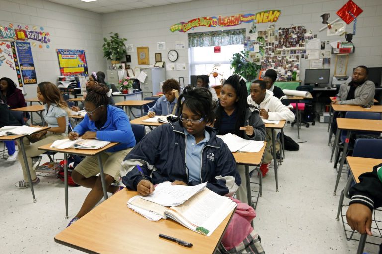In this Feb. 15, 2013 photograph, Clarksdale High School students delve into the complexities of chemistry equations, in Clarksdale, Miss. Community leaders hope improved education will help stanch a hemorrhaging population. The city's nine public schools may also be the crossroads of Mississippi's education system as state lawmakers are considering a new route, one characterized by charter schools, teacher merit pay, a tougher statewide curriculum, state-paid preschool classes and an intensive focus on reading for young students. (AP Photo/Rogelio V. Solis)