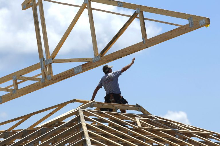 Construction workers build a commercial complex in Springfield, Ill. (AP/Seth Perlman)