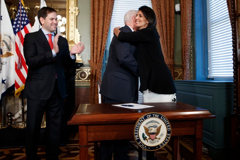 Sen. Marco Rubio, R-Fla. applauds at left as Vice President Mike Pence hugs former South Carolina Gov. Nikki Haley after filling out paperwork to make her the new U.S. Ambassador to the United Nations, Wednesday, Jan. 25, 2017, in the Vice Presidential Ceremonial Office in the Eisenhower Executive Office building on the White House complex in Washington. (AP Photo/Evan Vucci)