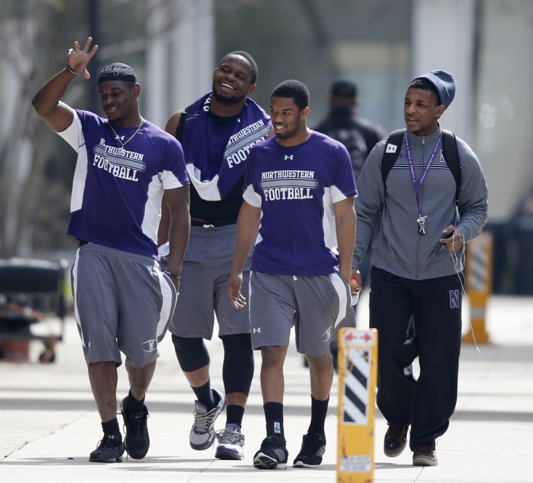 FILE - In this April 25, 2014, file photo, Northwestern football players walk between their locker room and McGaw Hall, where voting is taking place on the student athlete union question in Evanston, Ill. A national organization representing college and university presidents is disputing a federal ruling that students who receive college athletic scholarships are essentially employees of their schools and thus entitled to join unions and exercise collective-bargaining rights. Student-athletes participate for their own benefit; they do not render services for compensation, said the 1,800 member American Council on Education.  Ahead of a midnight deadline, the council filed a 30-page friend-of-the court brief taking strong issue with the ruling earlier this year by a National Labor Relations Board regional director that allows college athletes at Northwestern University to unionize.(AP Photo/Charles Rex Arbogast, File)