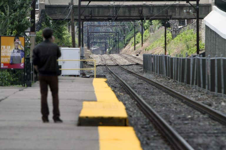 Unaware of the work stoppage Roy Pearson waits for a SEPTA commuter train at the East Falls commuter rail station in Philadelphia on Saturday June 14, 2014. Pennsylvania Gov. Tom Corbett asked President Barack Obama on Saturday to intervene the dispute between the Southeast Pennsylvania Transportation Authority and its engineers and electricians unions, which went on strike at midnight Friday, June 13. (AP Photo/ Joseph Kaczmarek)