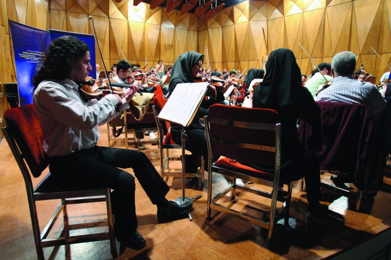 In this picture taken on Tuesday, Nov. 30, 2010, members of the Tehran Symphony Orchestra rehearse at the Roudaki hall in Tehran, Iran. Iran's national symphony orchestra has been disbanded for lack of funds, musicians said, another sign of the effects of Western economic sanctions. Orchestra members told the semiofficial ILNA news agency Monday Oct 29 2012 that they have not rehearsed together and have not been paid for three months(AP Photo/Vahid Salemi)