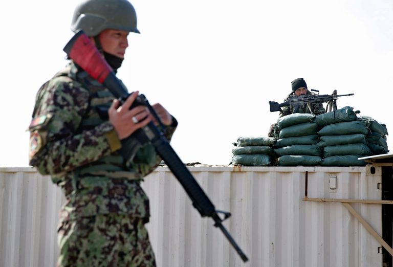 Afghan National Army soldiers stand guard near the main gate of the Parwan Detention Facility Center on the outskirts of Bagram, north of Kabul, Afghanistan, on Thursday. (AP Photo/Massoud Hossaini)