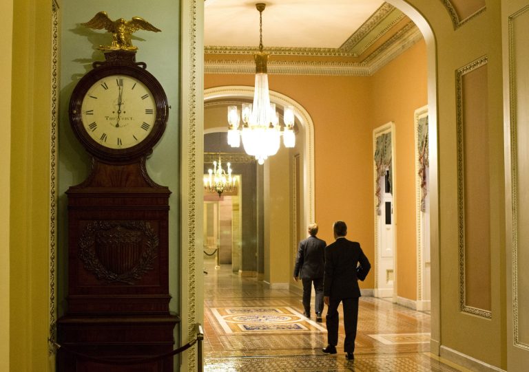 The Ohio Clock outside the Senate Chamber on Capitol Hill shows the time of 12:01 a.m. on Tuesday, Oct. 1 in Washington. Congress was unable to reach a midnight deadline to keep the government funded, triggering the first government shutdown in more than 17 years. (AP Photo/Evan Vucci)