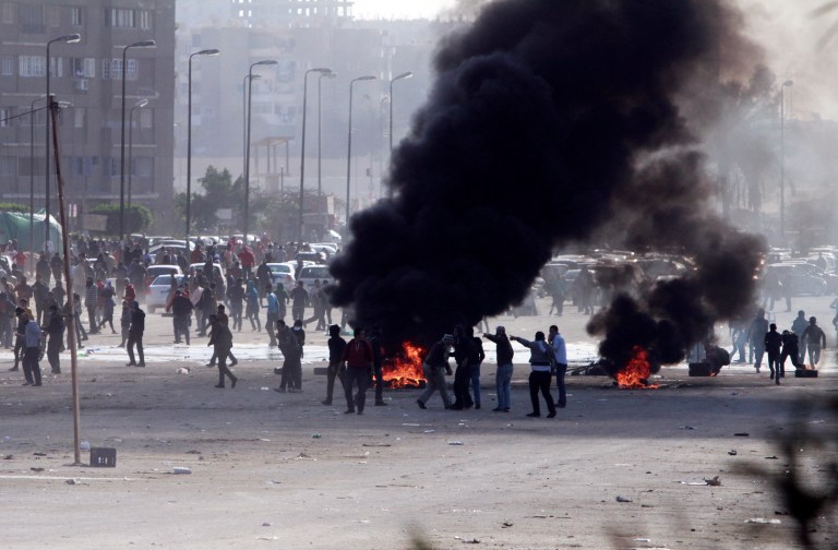 Supporters of ousted President Mohammed Morsi damage an area on a street as they protest against the government in Cairo's Nasr City district, Egypt, Friday, Jan, 24, 2014. A string of bombings hit police around Cairo on Friday, including a car blast that ripped through the city's main police headquarters and wrecked a nearby museum of Islamic artifacts. Later in the day, anti-Islamist residents joined police in clashes with Brotherhood members holding their daily protests in multiple cities around the country. (AP Photos/El Shorouk newspaper, Sabry Khaled) EGYPT OUT