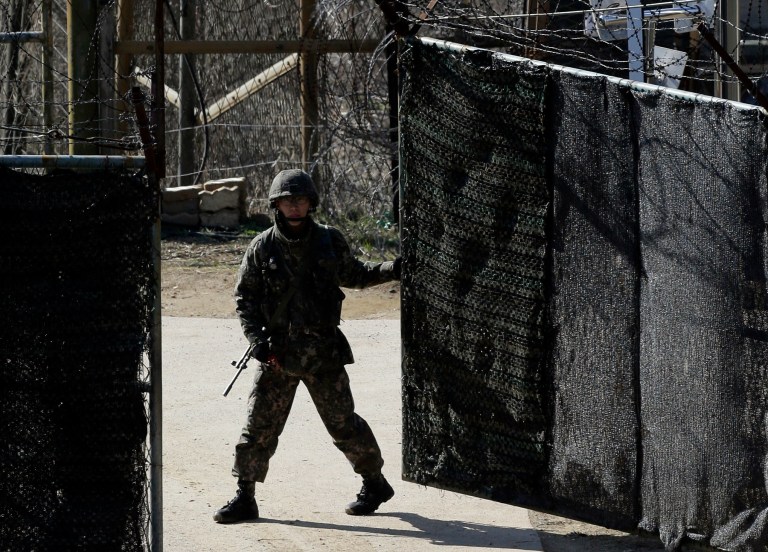 A South Korean soldier closes a military gate in Paju, north of Seoul, South Korea, Sunday, April 7, 2013. A top South Korean national security official said Sunday that North Korea may be setting the stage for a missile test or another provocative act with its warning that it soon will be unable to guarantee diplomats' safety in Pyongyang. But he added that the North's clearest objective is to extract concessions from Washington and Seoul. (AP Photo/Lee Jin-man)