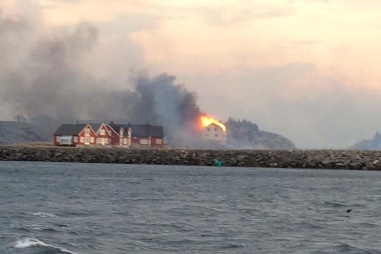 In this image taken from a rescue boat, buildings are seen on fire in Hasvaag, some 240 km north of Trondheim, Norway,  Tuesday, Jan. 28, 2014.  All of Hasvaag's 50-70 buildings have reportedly burned down. There have been no injuries, but all of the twenty people present have been evacuated. Many of the buildings are summer houses and cabins.  (AP Photo/NTB Scanpix, Redningsskoyta Harald V) NORWAY OUT