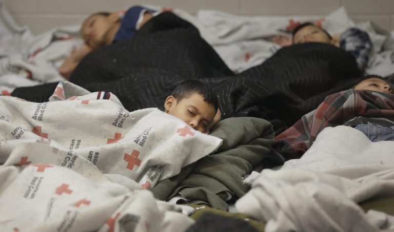 Detainees sleep in a holding cell at a U.S. Customs and Border Protection, processing facility in Brownsville,Texas, in this June 18, 2014, file photo. (AP Photo/Eric Gay, Pool, File)