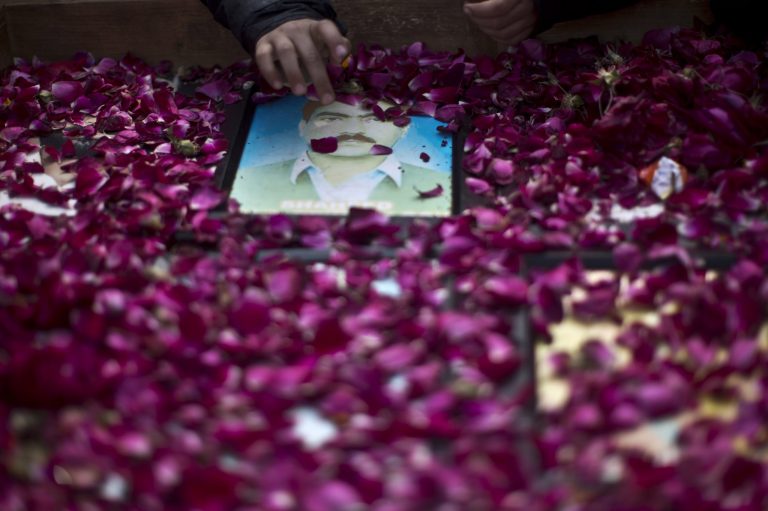 Photographs of missing people are covered with rose petals during a march in Rawalpindi, Pakistan, Friday, Feb. 28, 2014. Affected families walked nearly 3,000 kilometers to reach capital Islamabad and register protest against the abductions and killings of their loved ones by Pakistani security agencies without producing them in court of law.  (AP Photo/Muhammed Muheisen)