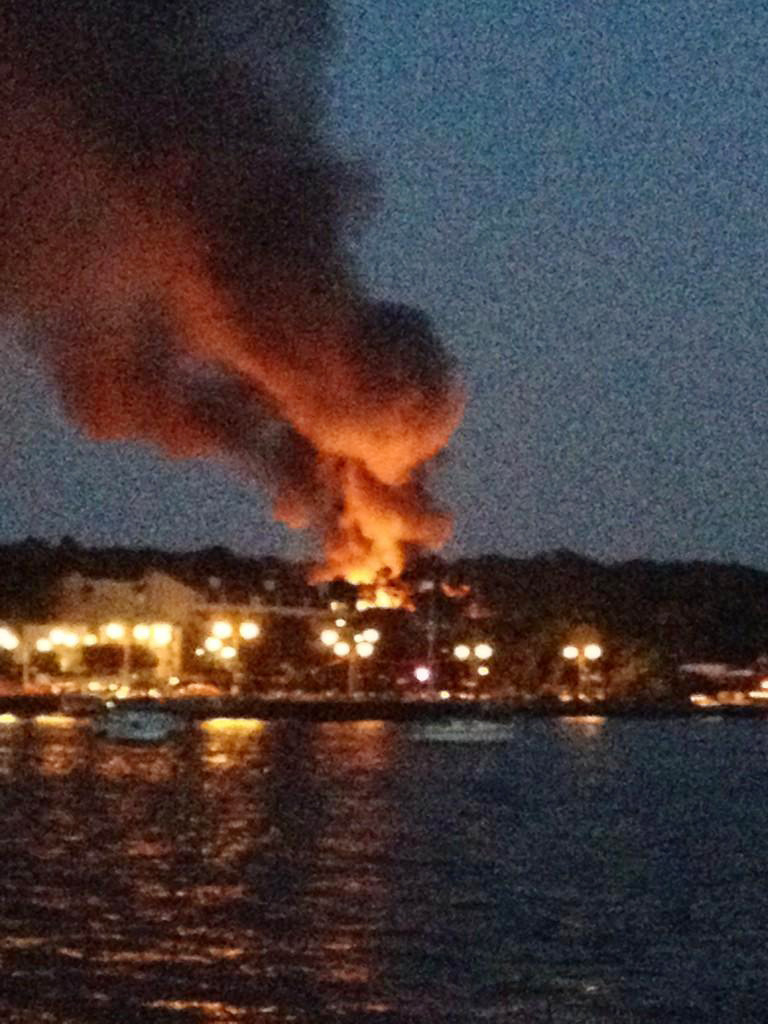 In this photo provided by Angela Dicaterino, flames and smoke emerge from a home in Port Washington, N.Y., Tuesday, Aug. 5, 2014. (AP Photo/Angela Dicaterino)